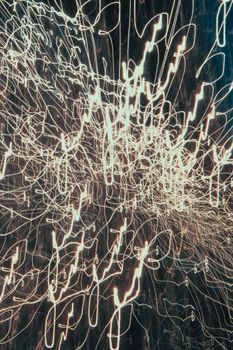 Abstract light trails forming intricate patterns on a dark background, showcasing movement and energy.