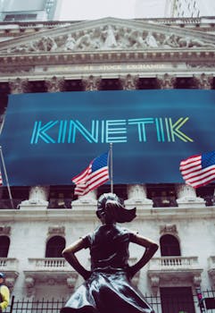 Dynamic shot of the Fearless Girl statue facing the New York Stock Exchange building.