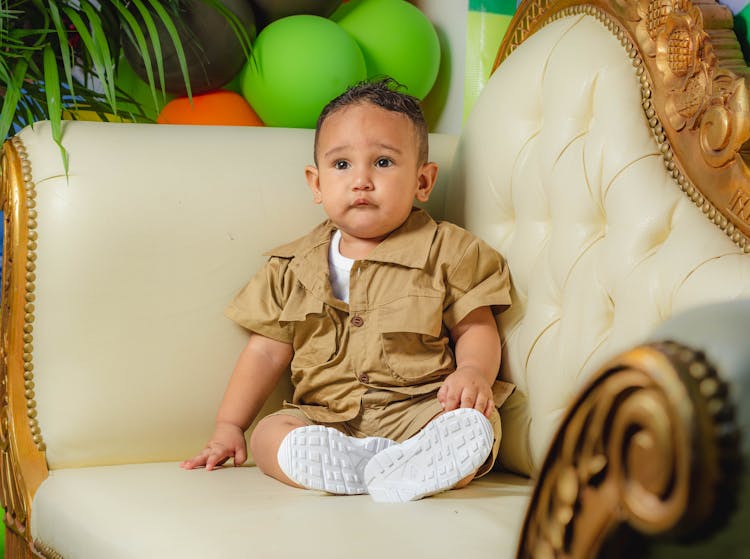 Toddler Sitting On Sofa