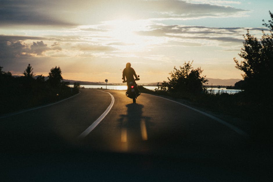 Person Riding Motorcycle during Golden Hour