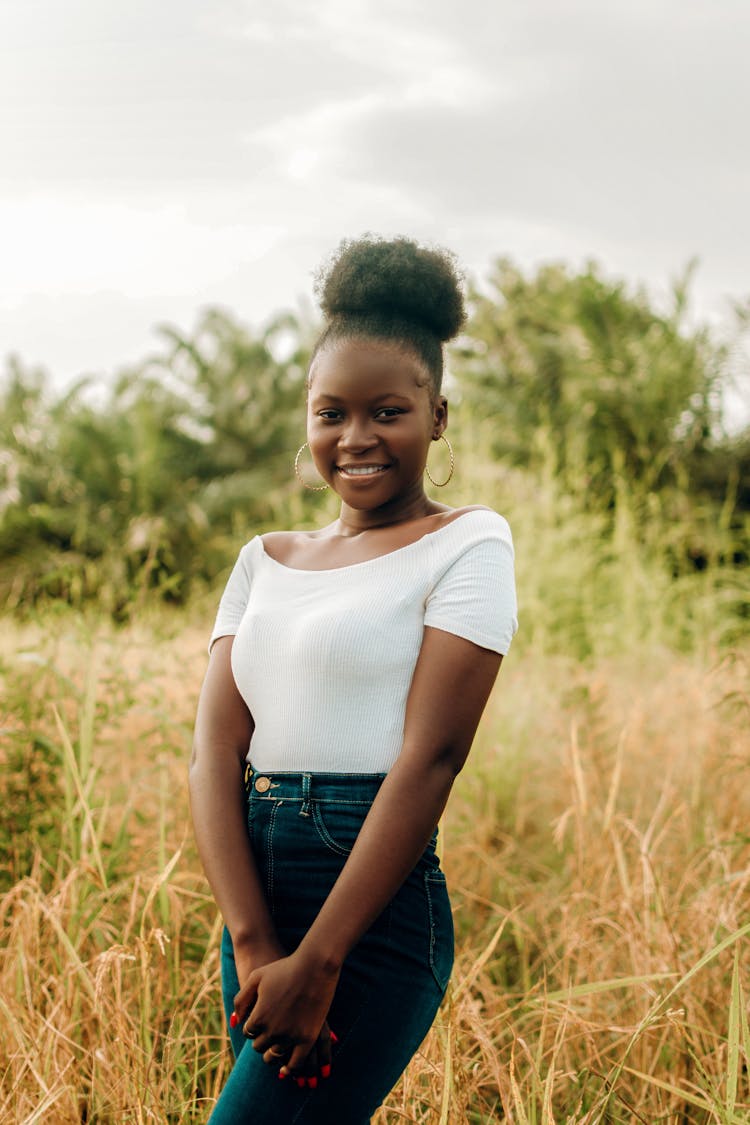 Smiling African Beauty Standing In Grassland