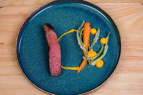 Steak with Vegetables on a Blue Ceramic Plate 