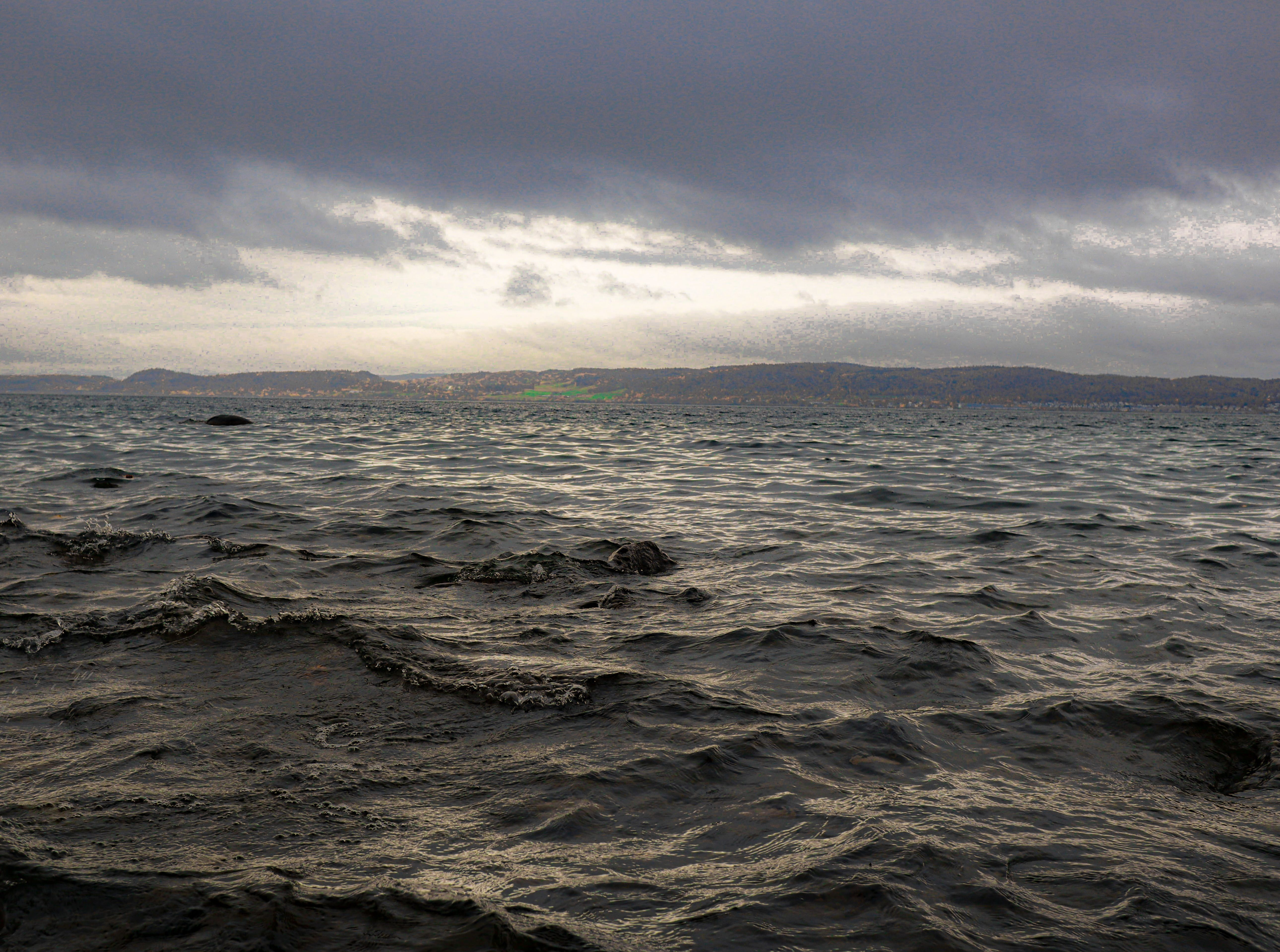 Dark Body of Water Under Cloudy Sky · Free Stock Photo