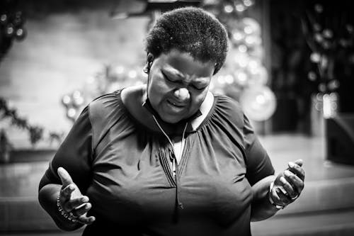 Woman Standing and Praying in Black and White