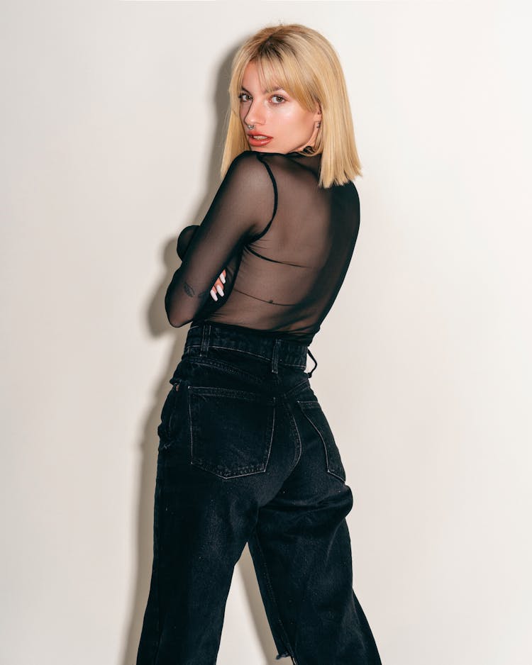 Blonde Woman Posing In Black Outfit