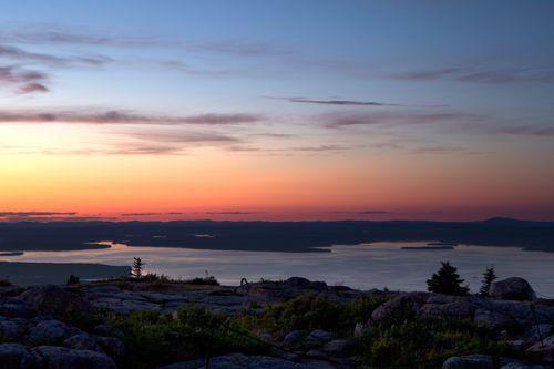 Free Stunning view of the ocean at sunrise with vivid sky colors and rocky shore. Stock Photo