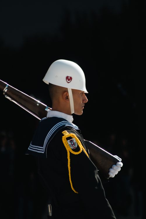 Free Close-up of a helmeted navy soldier with a rifle on shoulder in outdoor setting. Stock Photo