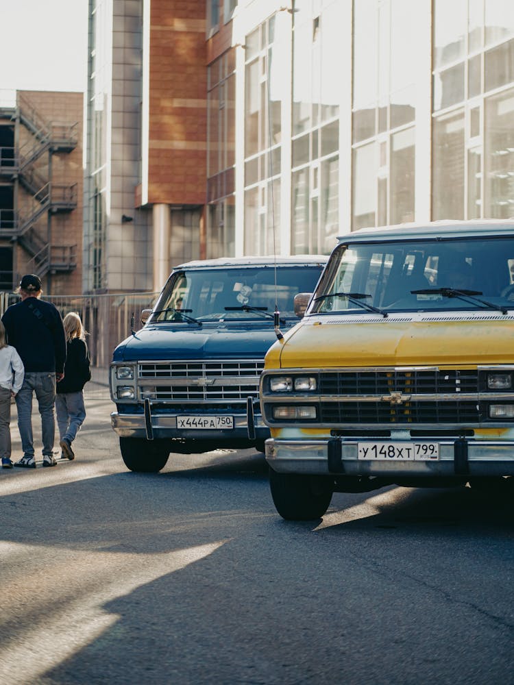 Vintage Chevrolet Vans Parked On A City Street