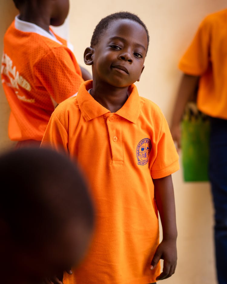 Boy In Orange Polo Shirt