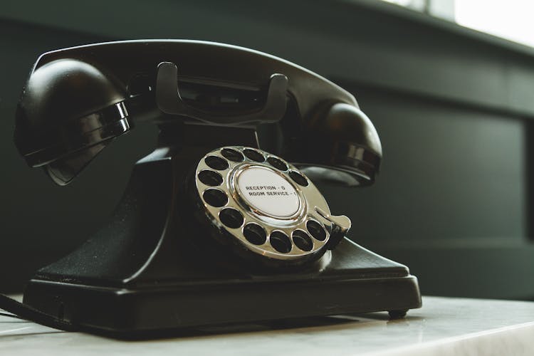 Black Rotary Telephone On White Surface