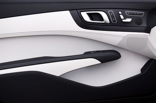 Free Close-up of a modern car door panel with a minimalist design and luxury materials. Stock Photo