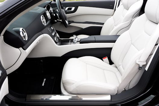 Elegant interior of a luxury sports car featuring white leather seats and sleek design.