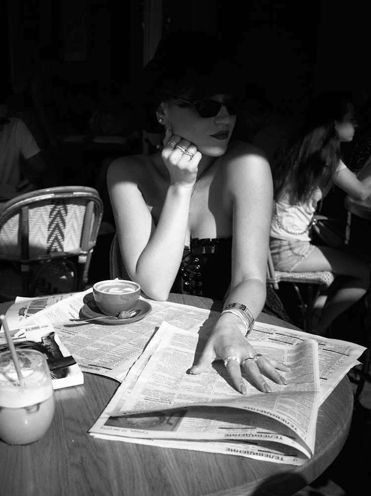 Woman Posing With Newspapers On Table