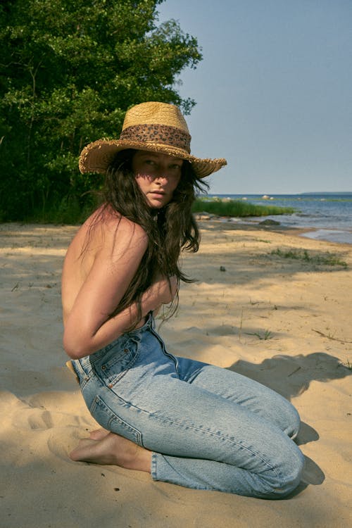 Woman Posing Topless on Beach