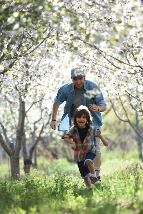 Father Playing with His Little Son in the Orchard