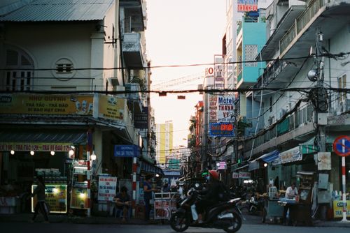 Free Colorful busy street scene in Cần Thơ, Vietnam with vibrant signs and people. Stock Photo