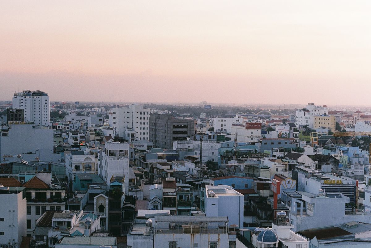 Can Tho rooftops and taller city buildings at dusk
