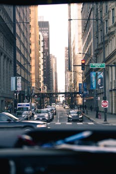 Urban cityscape of busy street in Chicago with skyscrapers and traffic.