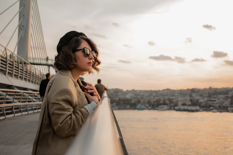 Woman Wearing Sunglasses Standing Near Handrail