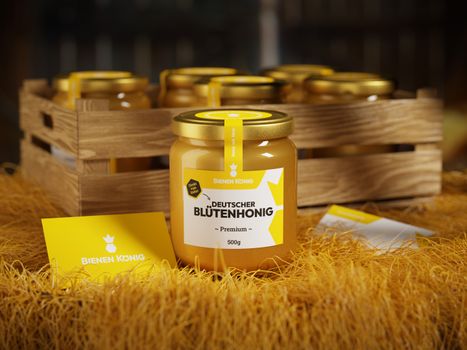 Jar of premium German flower honey on straw with other jars in a wooden crate.