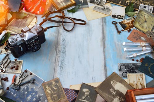 A vintage camera surrounded by nostalgic photos, old keys, and memorabilia on a rustic wooden surface.