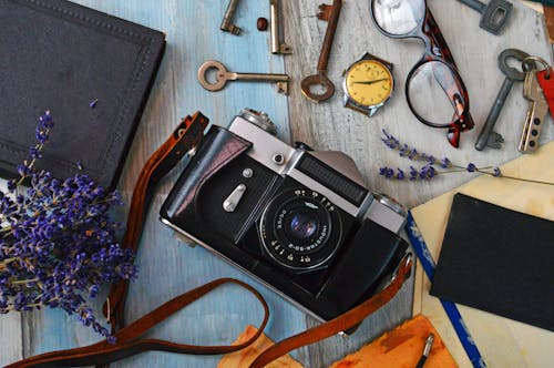 Black and Gray Camera Near Brass-colored Keys