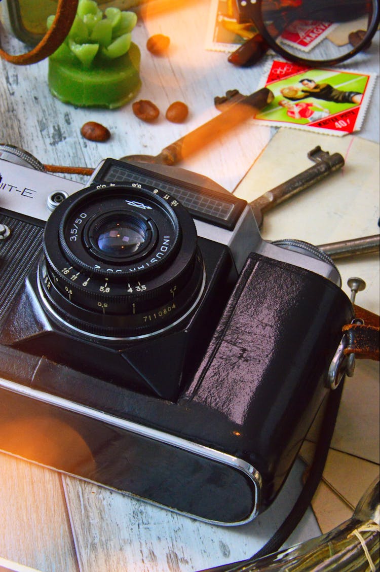 Black And Gray Camera On Table Beside Of Skeleton Keys