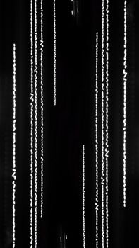 Minimalist abstract photo with vertical white lines on black backdrop, creating a beaded pattern effect.