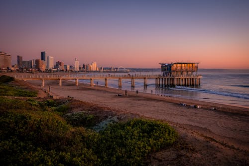 Sea, Beach, Pier, City in Background