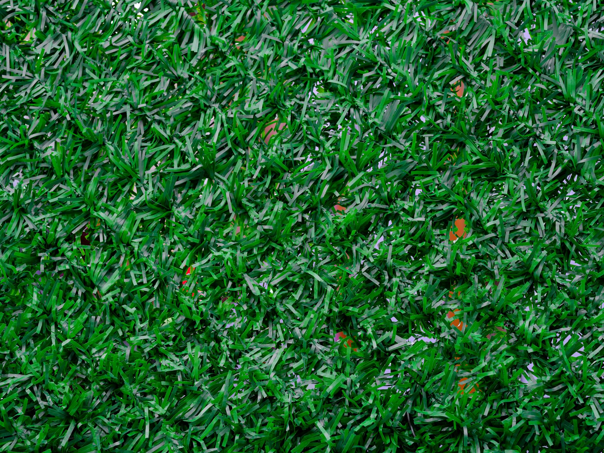 Vibrant close-up image of synthetic green grass, perfect for backgrounds.