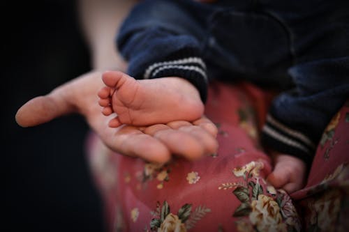 Mother Hand Holding Baby Foot