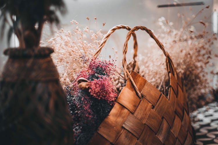 A Woven Basket With Dried Flowers