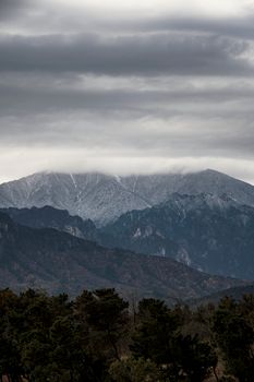 View of cloud-covered mountains and forest in Goseong, South Korea, under overcast skies.
