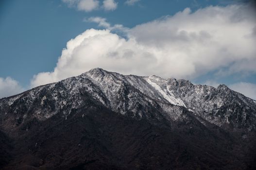 Breathtaking view of snow-capped mountains beneath a vibrant blue sky in Gangwon-do, South Korea.