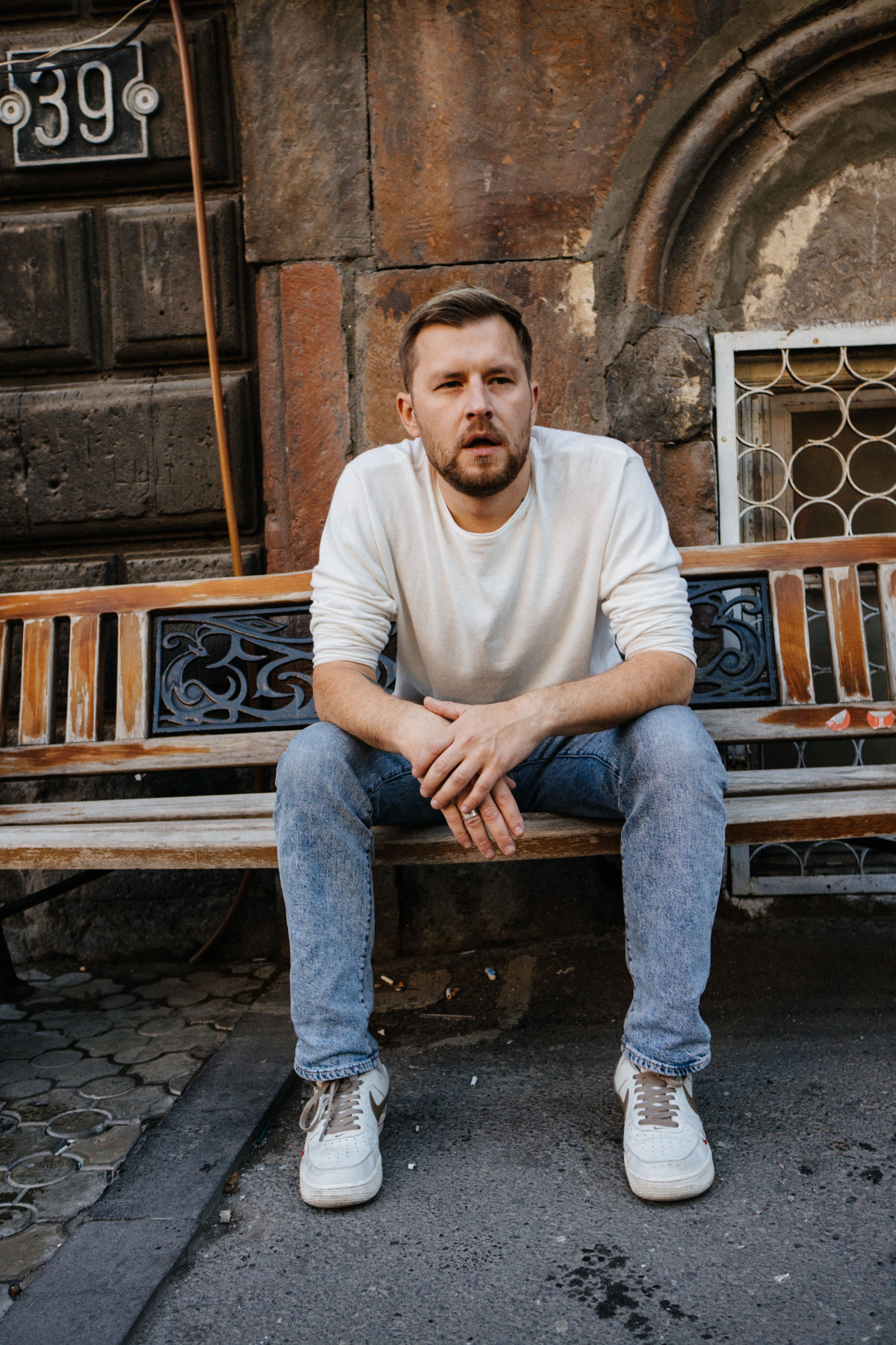 Casual portrait of a man sitting on a bench in Yerevan, Armenia.