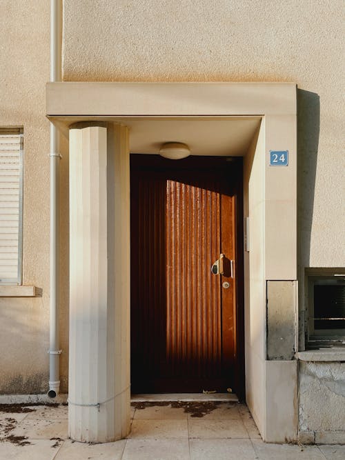 Brown Wooden Door of Concrete House