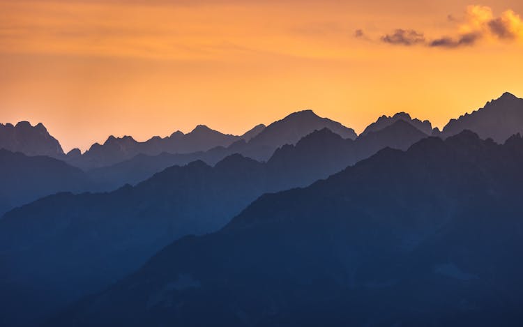 Silhouette Of Mountains Under Golden Sky