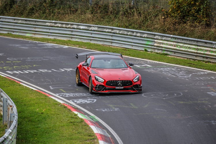 Red Racing Car Moving On A Track