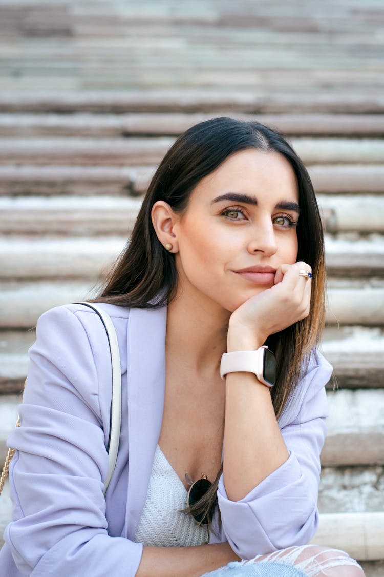 Woman Wearing A Lilac Jacket Sitting On Steps