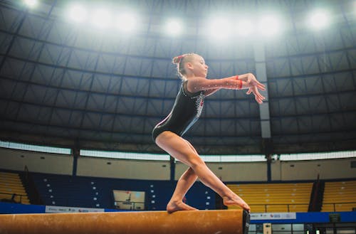 Free A Girl in Black Leotards Standing on Balance Beam Stock Photo