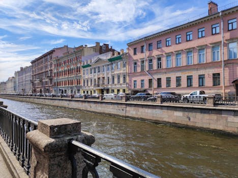 Colorful historic buildings line a canal in Saint Petersburg, Russia.