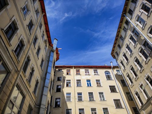 Low Angle Shot oof Concrete Buildings Under Blue Sky