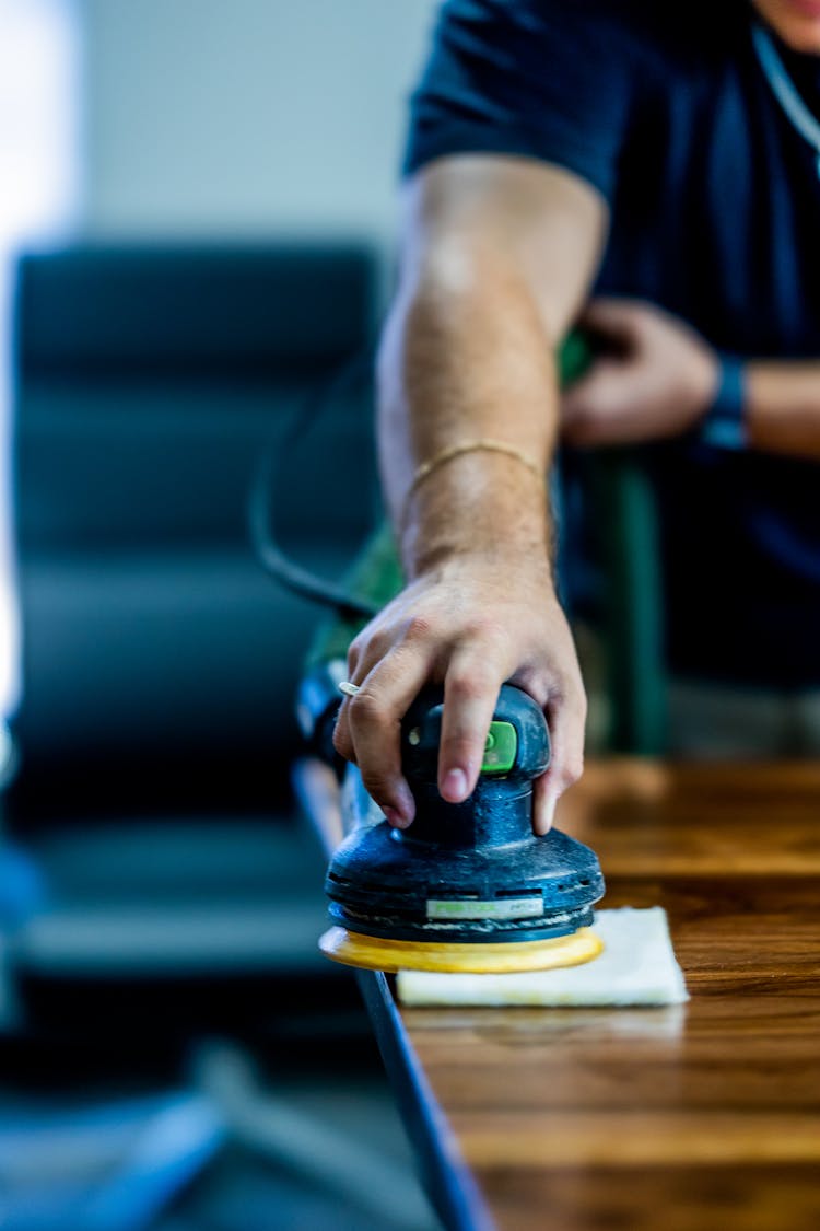 A Person Using A Buffing Machine