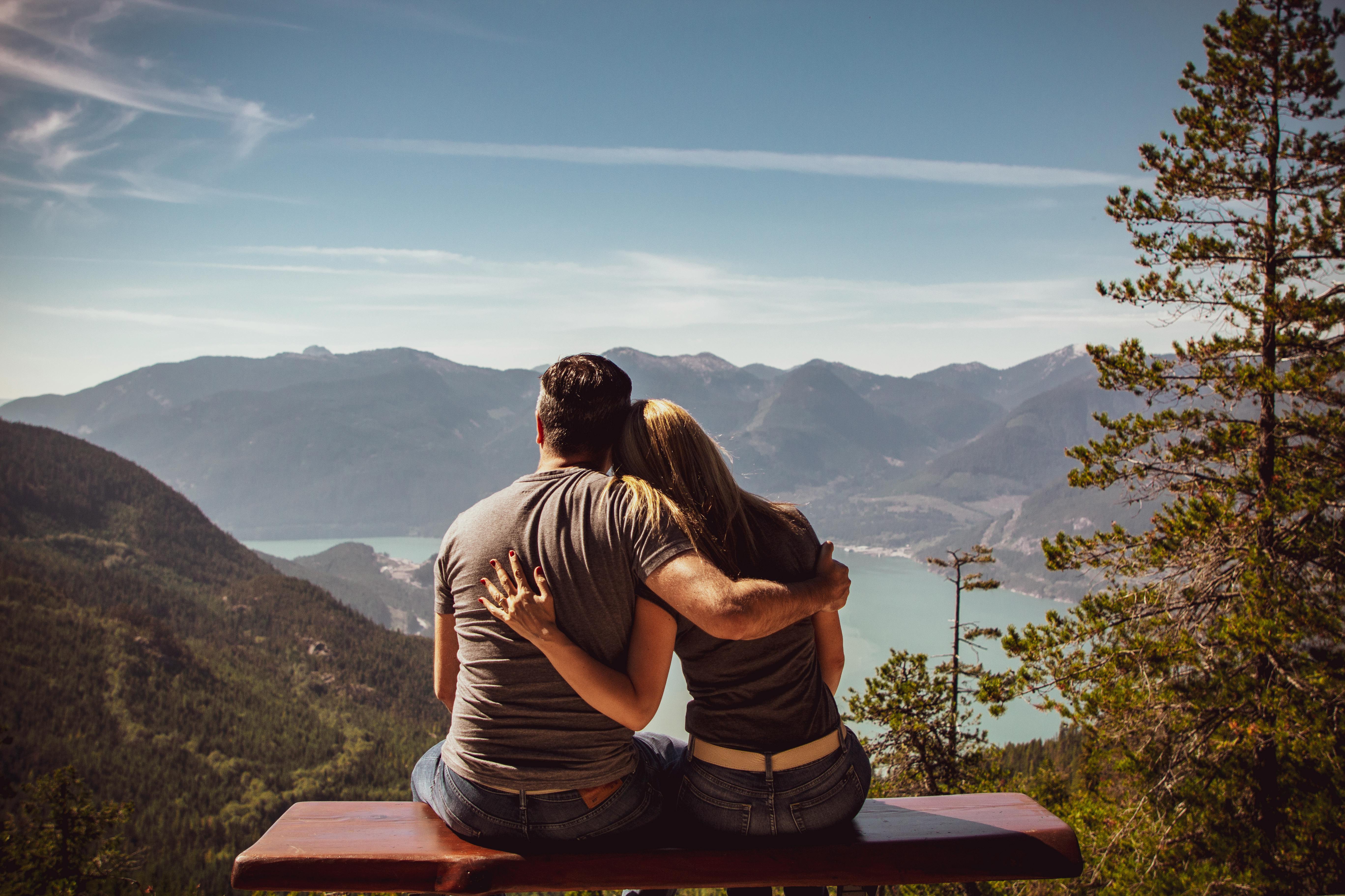 man and woman sitting on bench