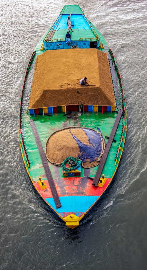 Green and Blue Boat on Body of Water