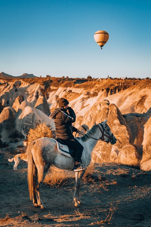 Person Horseback Riding in Volcanic Scenery