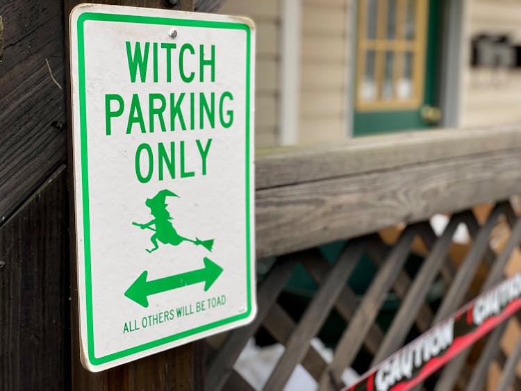 A Witch Parking Only Sign On Wooden Wall