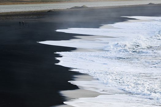 Aerial view of the stunning black sand beach in Vik, Iceland with ocean waves crashing ashore.. pexels, aerial, view