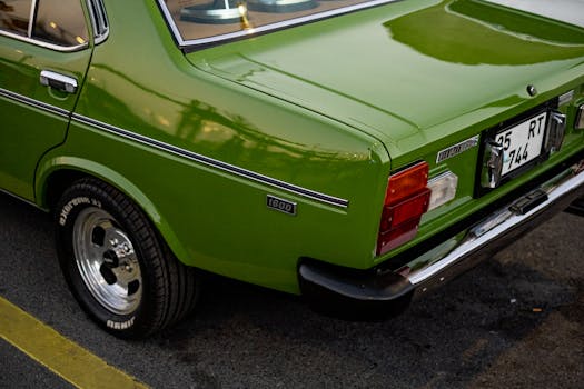 Rear view of a vintage green car on a street in İstanbul, Türkiye.
