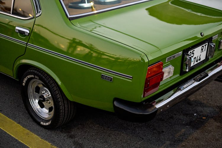 A Green Classic Car Parked On The Street